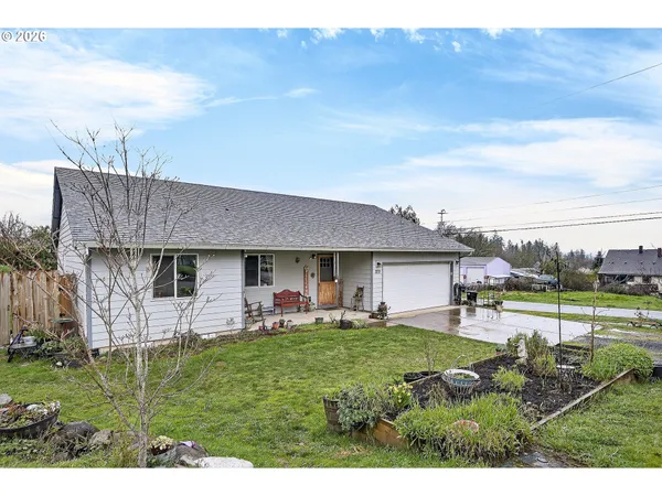 a view of a house with a yard and sitting area