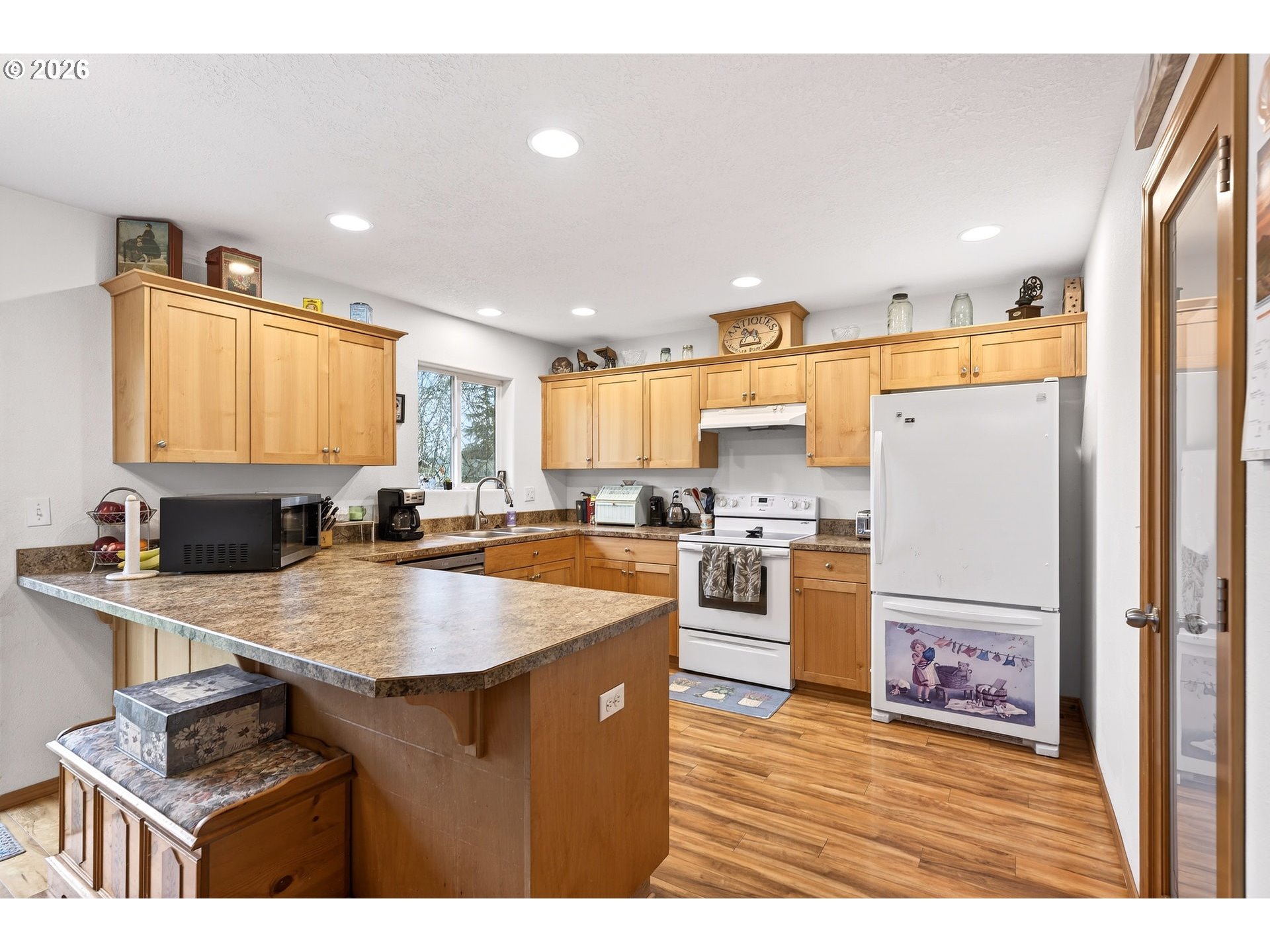 720 Market Street Lafayette, OR 97127 - Photo 11 of 35 a kitchen with refrigerator cabinets and wooden floor