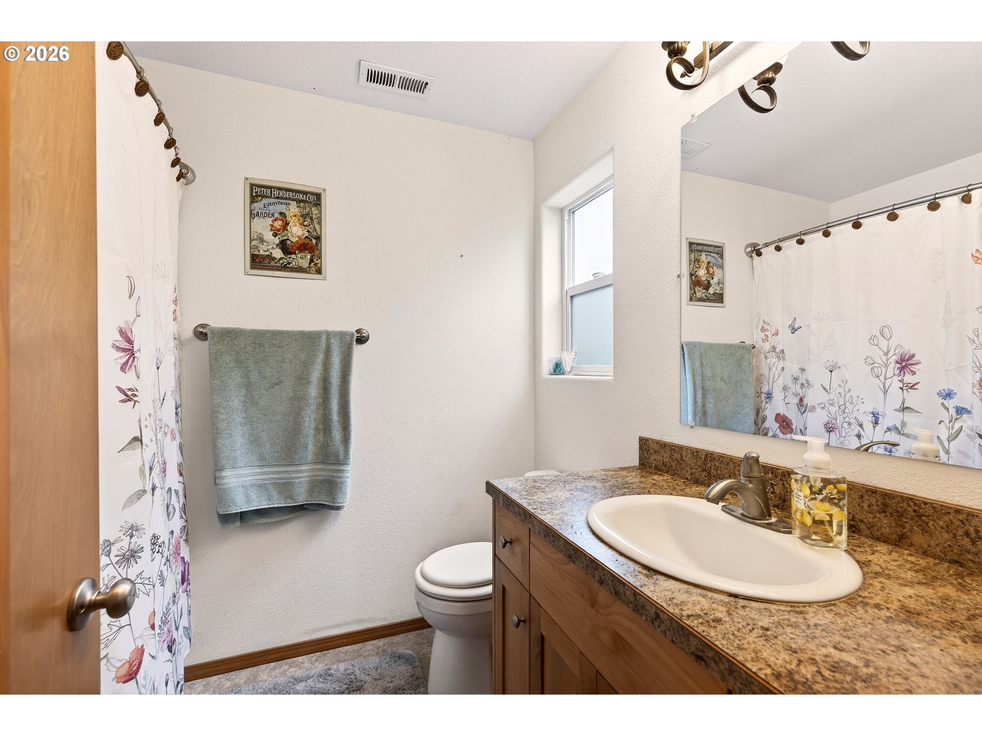 720 Market Street Lafayette, OR 97127 - Photo 18 of 35 a bathroom with a granite countertop sink a mirror a toilet and a shower