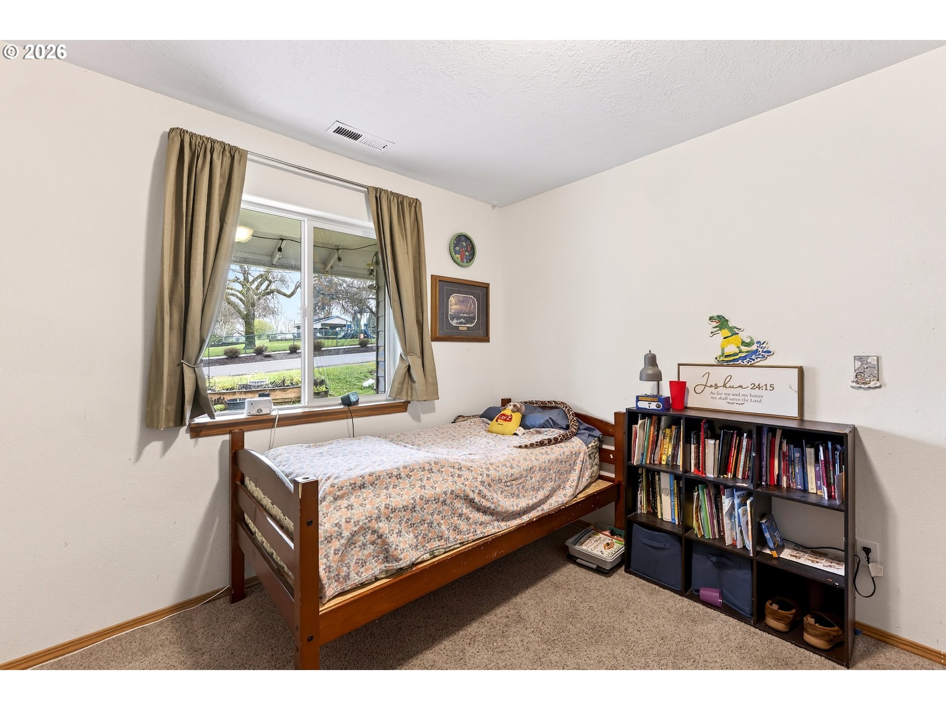 720 Market Street Lafayette, OR 97127 - Photo 19 of 35 a bedroom with a bed window and a book shelf