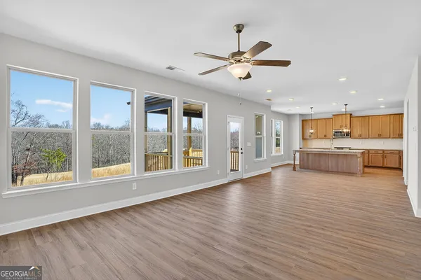 a kitchen with center island wooden floor and a sink