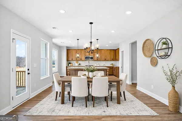 a kitchen with stainless steel appliances granite countertop a sink a stove and a wooden floors