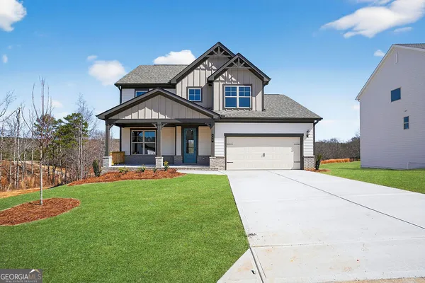 a front view of a house with swimming pool having outdoor seating