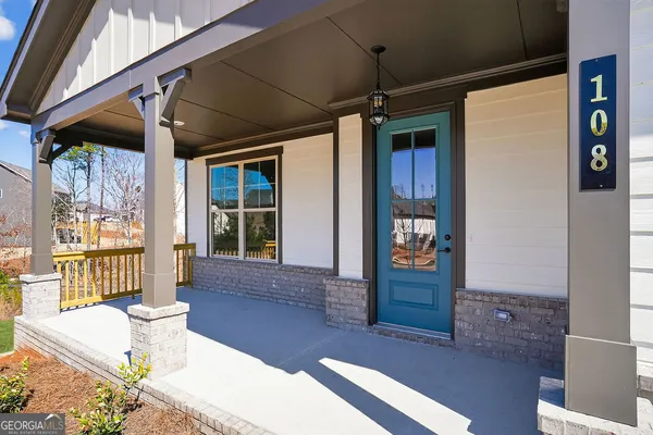 a front view of a house with outdoor seating