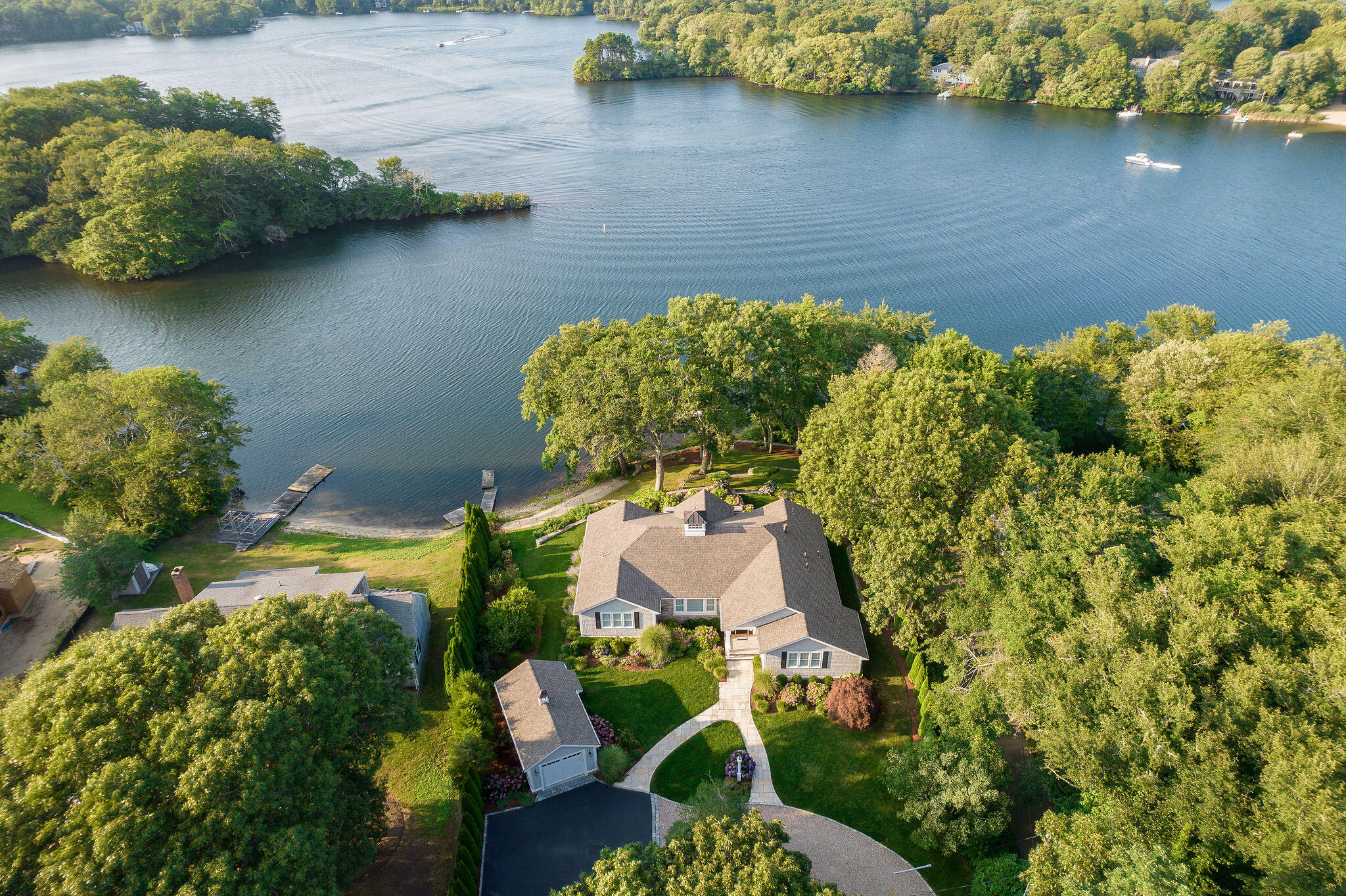 256 Holly Point Road Centerville, MA 02632 - Photo 1 of 53 an aerial view of a house with a yard and lake view