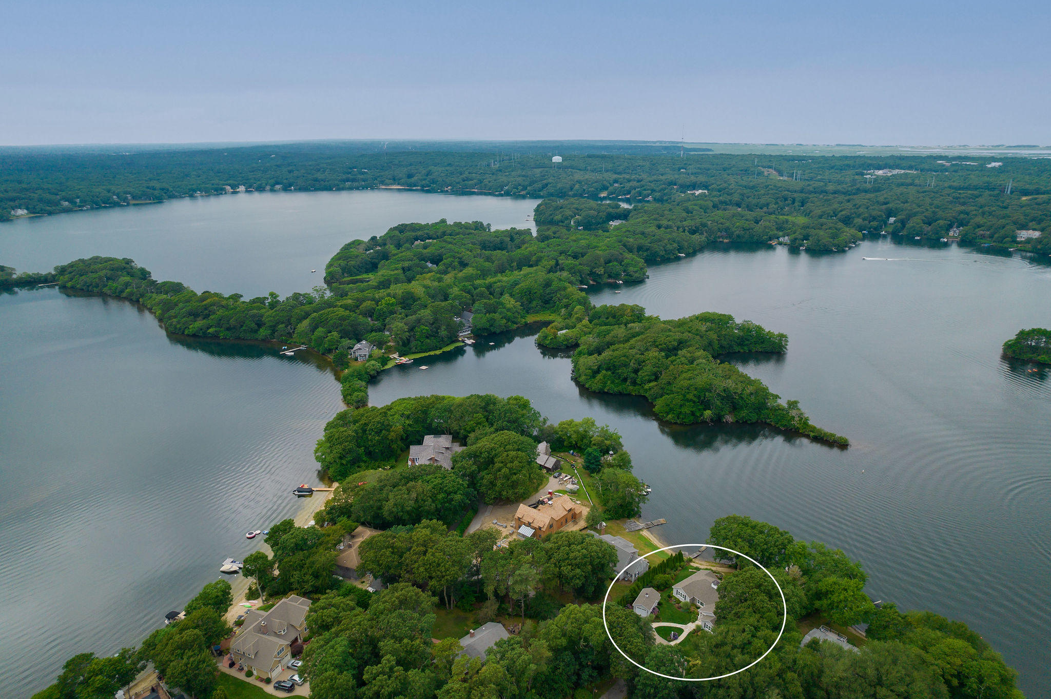 256 Holly Point Road Centerville, MA 02632 - Photo 5 of 53 a view of a lake with a house in the background