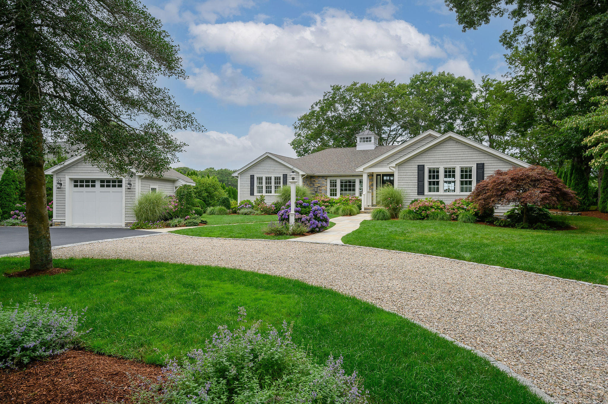 256 Holly Point Road Centerville, MA 02632 - Photo 9 of 53 a front view of a house with a yard and green space