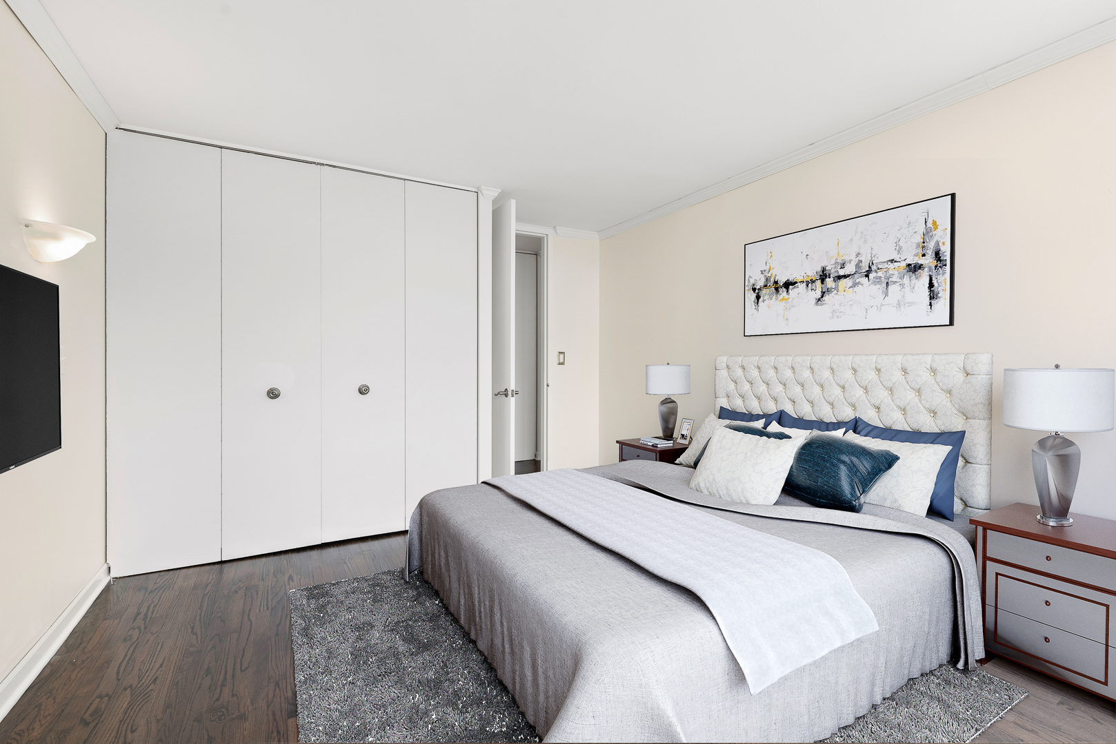 655 West Irving Park Road, Unit 4511 Chicago, IL 60613 - Photo 5 of 10 a bedroom with a bed and a painting on the wall