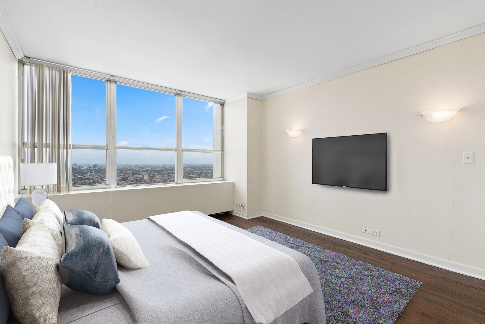 655 West Irving Park Road, Unit 4511 Chicago, IL 60613 - Photo 6 of 10 a bedroom with a bed and a flat screen tv