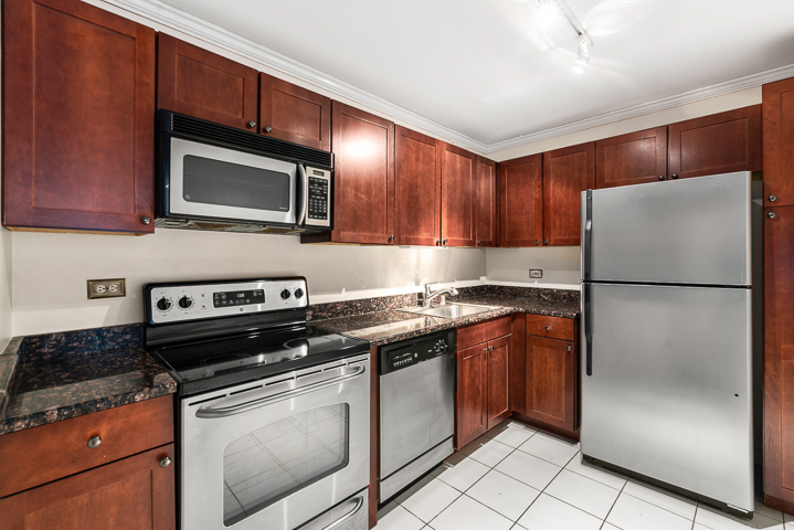 655 West Irving Park Road, Unit 4511 Chicago, IL 60613 - Photo 7 of 10 a kitchen with stainless steel appliances granite countertop a refrigerator stove a sink and dishwasher