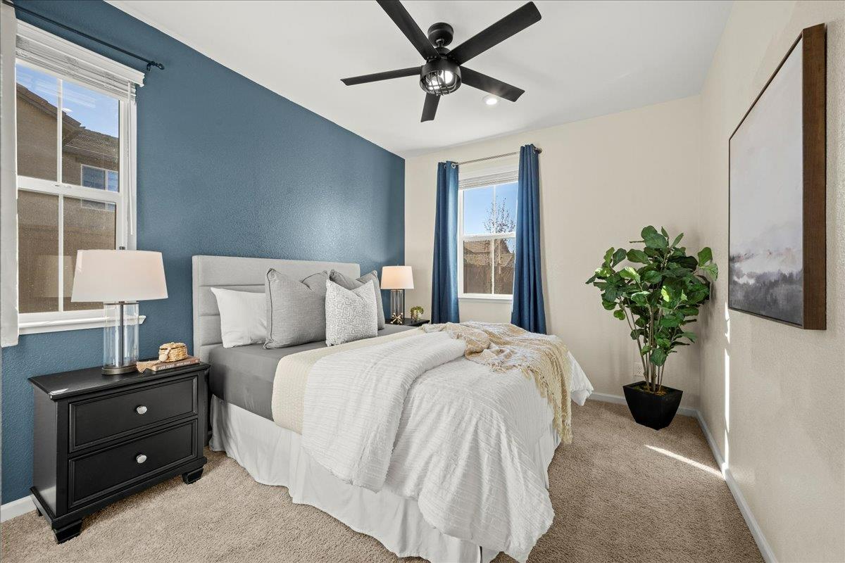 4828 Aldridge Ravine Court Folsom, CA 95630 - Photo 15 of 43 a bedroom with a bed and a potted plant