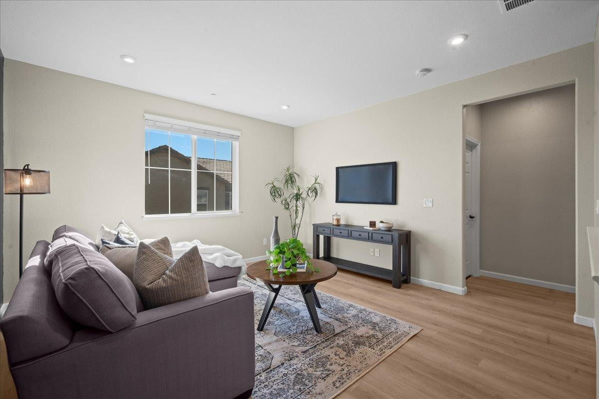 4828 Aldridge Ravine Court Folsom, CA 95630 - Photo 19 of 43 a living room with furniture and a flat screen tv