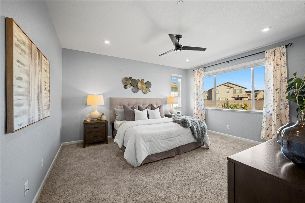 4828 Aldridge Ravine Court Folsom, CA 95630 - Photo 21 of 43 a spacious bedroom with a bed and a flat screen tv
