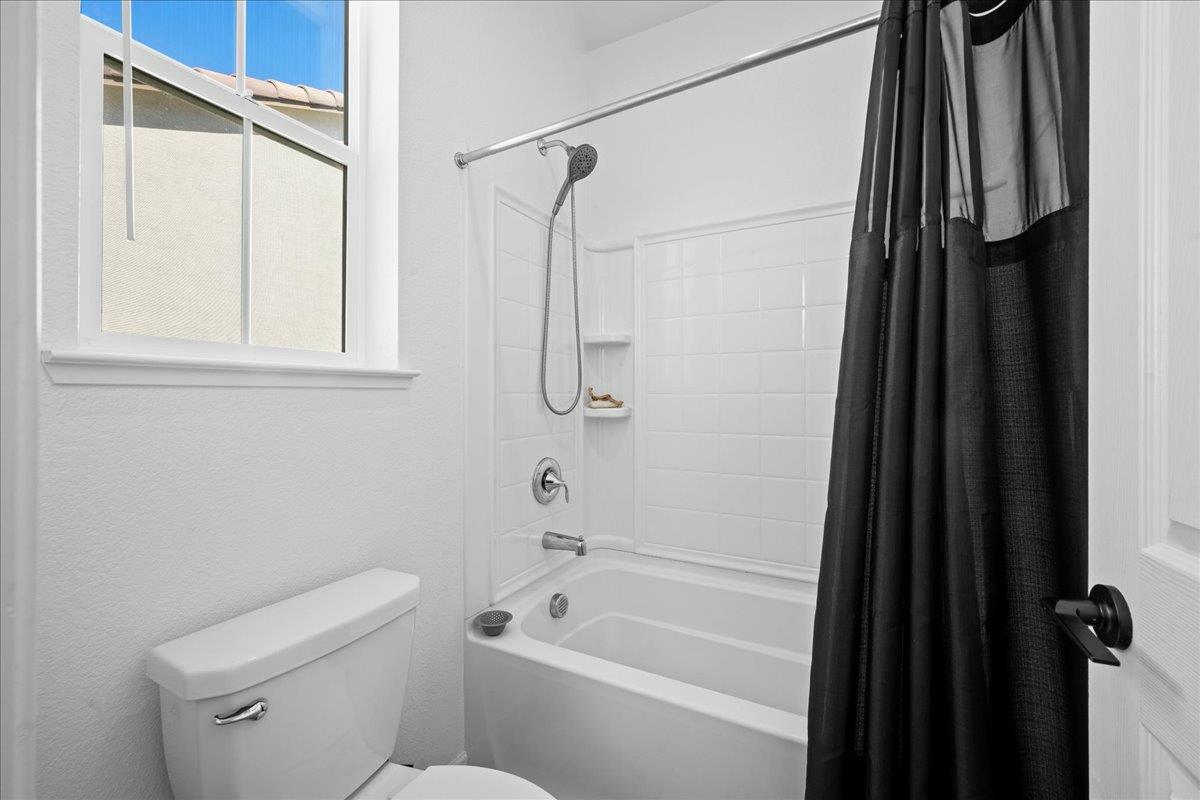 4828 Aldridge Ravine Court Folsom, CA 95630 - Photo 28 of 43 a bathroom with a shower a toilet and a tub