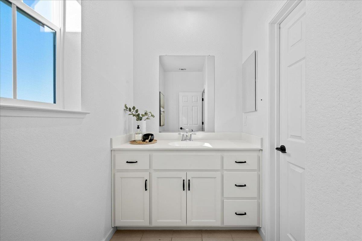 4828 Aldridge Ravine Court Folsom, CA 95630 - Photo 29 of 43 a bathroom with a sink vanity and mirror