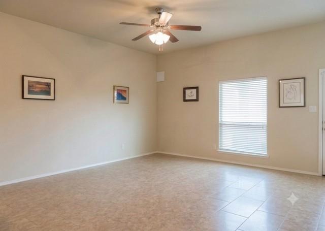 415 Harding Lane Lavon, TX 75166 - Photo 12 of 13 Spacious room featuring neutral tone walls, tile flooring, a window with horizontal blinds, and a ceiling fan with integrated lighting