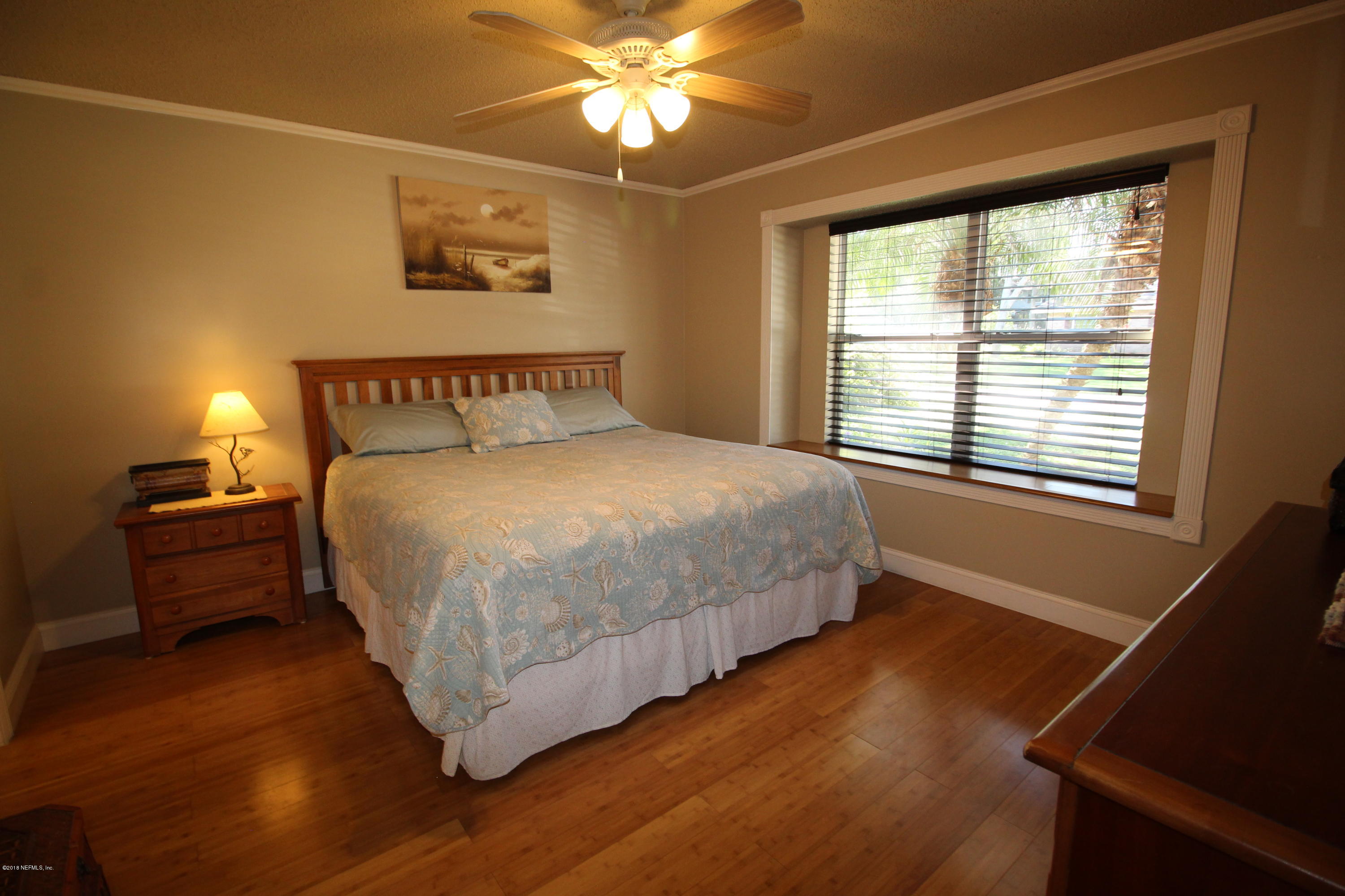 237 Wisteria Road St. Augustine, FL 32086 - Photo 8 of 37 a bedroom with a bed and a window with a bookshelf