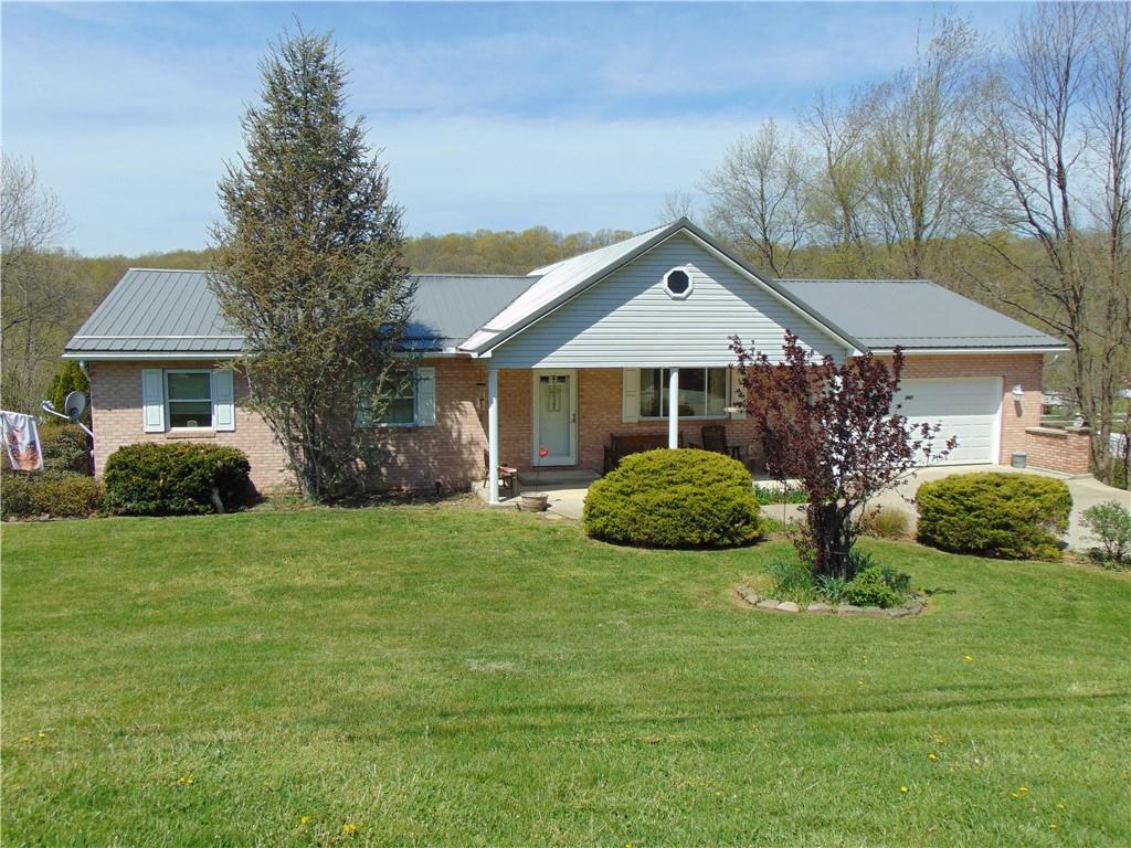 361 Adelaide Road Connellsville, PA 15425 - Photo 1 of 35 a front view of a house with garden