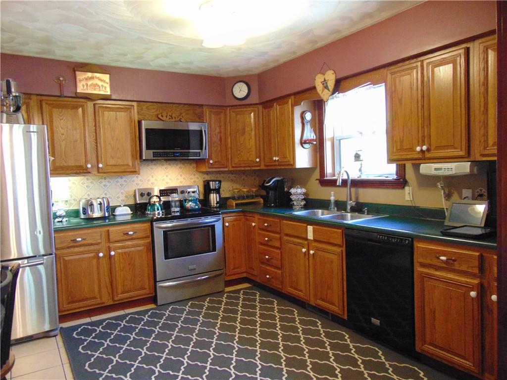 361 Adelaide Road Connellsville, PA 15425 - Photo 3 of 35 a kitchen with stainless steel appliances granite countertop a stove a sink and a microwave