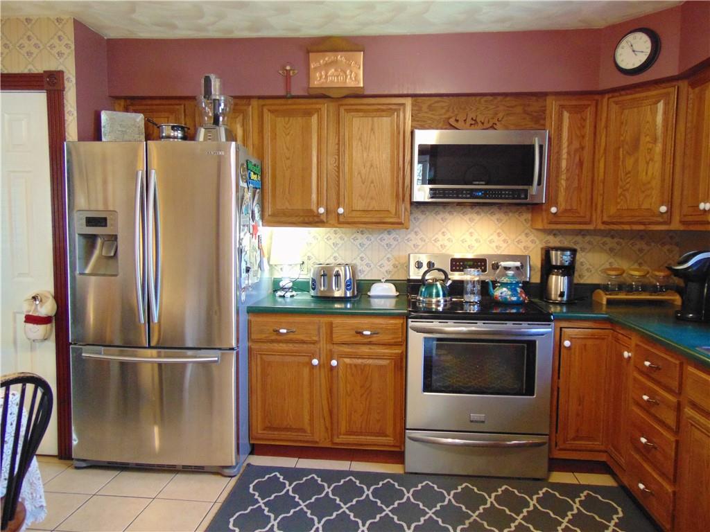 361 Adelaide Road Connellsville, PA 15425 - Photo 4 of 35 a kitchen with stainless steel appliances granite countertop a refrigerator stove and microwave