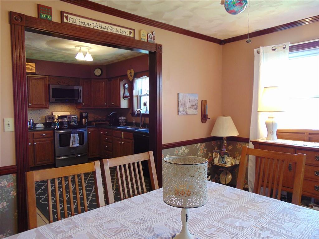 361 Adelaide Road Connellsville, PA 15425 - Photo 8 of 35 a kitchen with stainless steel appliances kitchen island granite countertop a sink dishwasher a dining table and chairs with wooden floor
