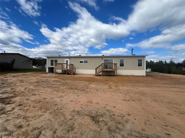 a view of house with a yard