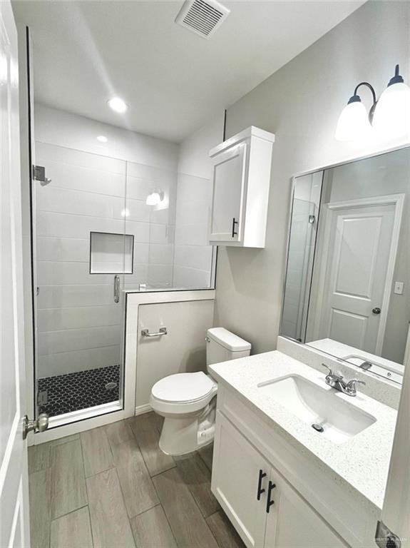 1635 Playa Drive, Unit 2 Weslaco, TX 78596 - Photo 13 of 17 a bathroom with a sink toilet and shower