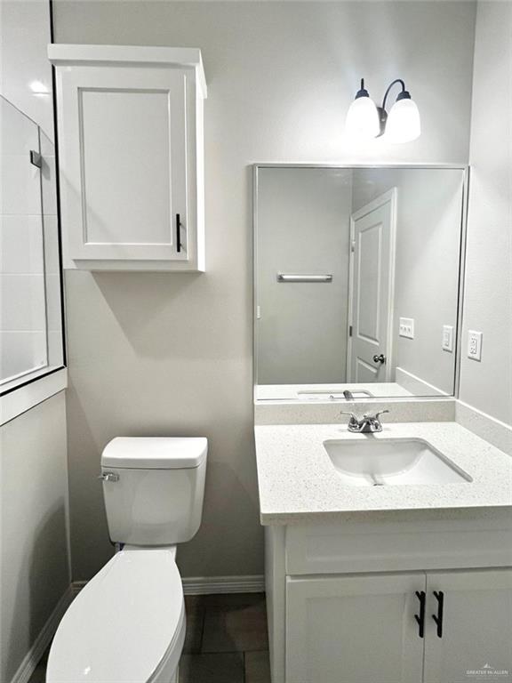 1635 Playa Drive, Unit 2 Weslaco, TX 78596 - Photo 15 of 17 a bathroom with a toilet sink and mirror