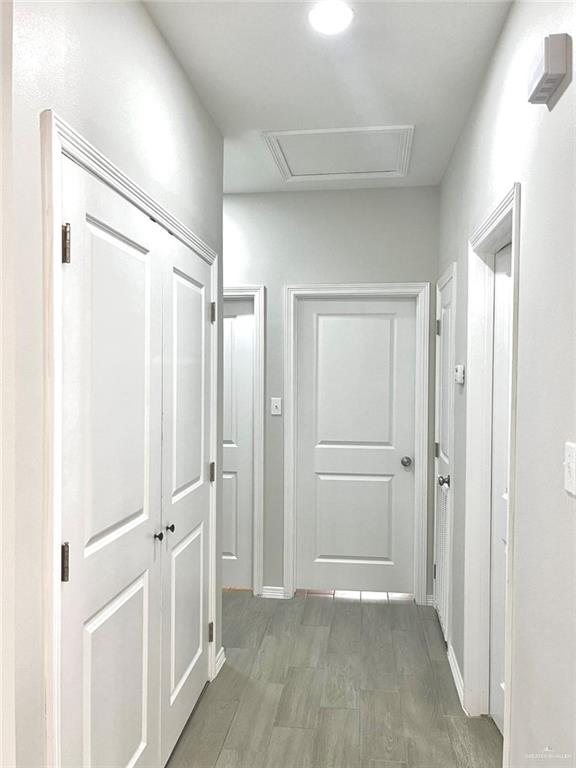 1635 Playa Drive, Unit 2 Weslaco, TX 78596 - Photo 16 of 17 a view of a hallway with wooden shelves