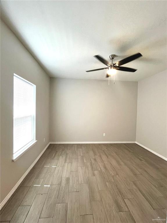 1635 Playa Drive, Unit 2 Weslaco, TX 78596 - Photo 17 of 17 wooden floor in an empty room with a window