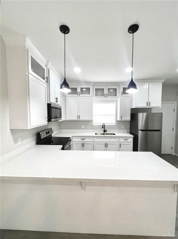 1635 Playa Drive, Unit 2 Weslaco, TX 78596 - Photo 7 of 17 a large kitchen with kitchen island a counter a sink stainless steel appliances and cabinets