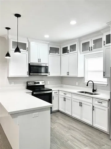 a kitchen with white cabinets and a sink