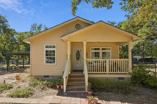 a front view of a house with garden