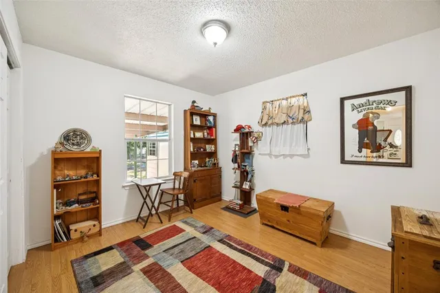 a bedroom with furniture and a book shelf