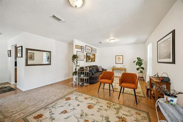 a living room with furniture and wooden floor