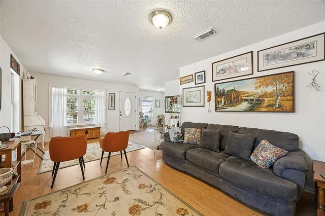 a living room with furniture and large windows