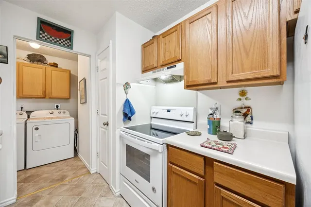 a kitchen with cabinets appliances and a sink
