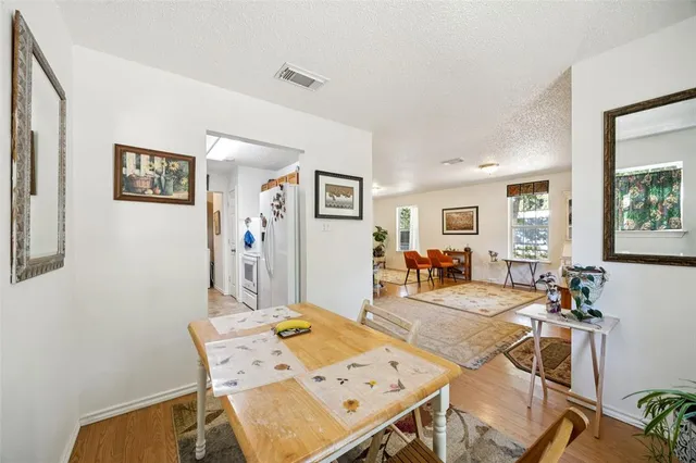 a view of a dining room with furniture and a window