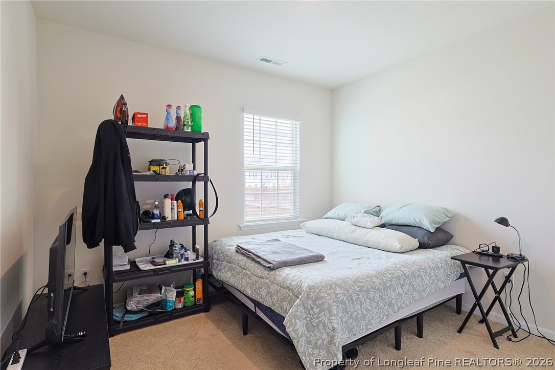 2129 Clydesmill Road Fayetteville, NC 28314 - Photo 12 of 36 a bedroom with a bed and a book shelf