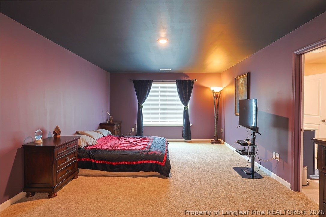 2129 Clydesmill Road Fayetteville, NC 28314 - Photo 16 of 36 a bedroom with a bed and a flat tv screen on the dresser