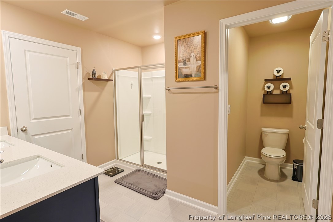 2129 Clydesmill Road Fayetteville, NC 28314 - Photo 17 of 36 a bathroom with a sink a toilet and shower