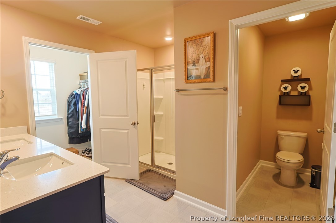 2129 Clydesmill Road Fayetteville, NC 28314 - Photo 18 of 36 a bathroom with a sink a toilet and shower