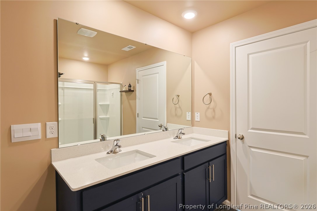 2129 Clydesmill Road Fayetteville, NC 28314 - Photo 20 of 36 a bathroom with 2 sink and a mirror