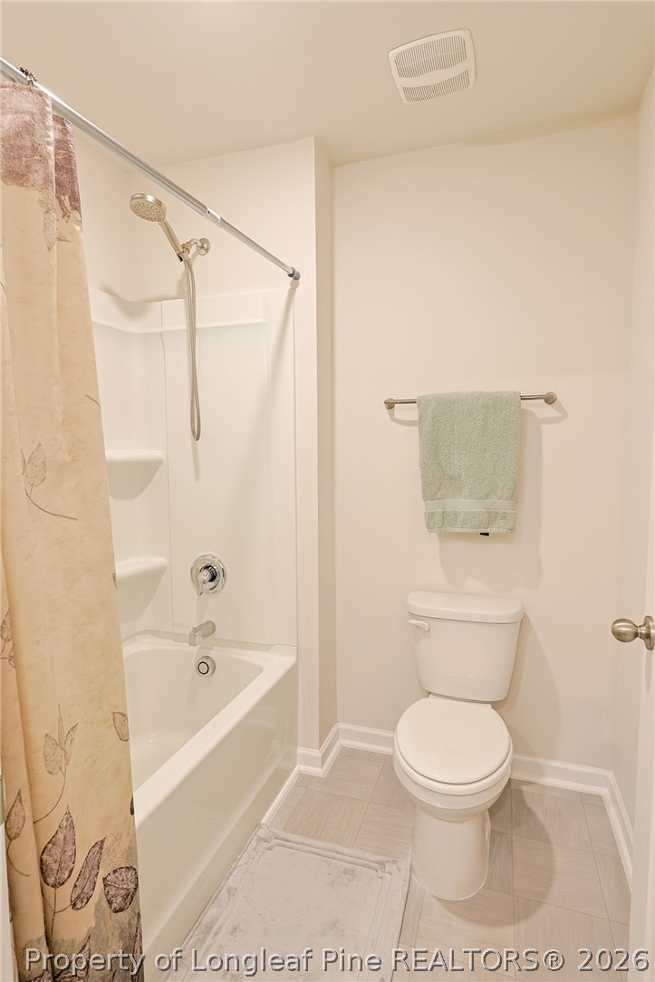 2129 Clydesmill Road Fayetteville, NC 28314 - Photo 28 of 36 a bathroom with a toilet and a bathtub