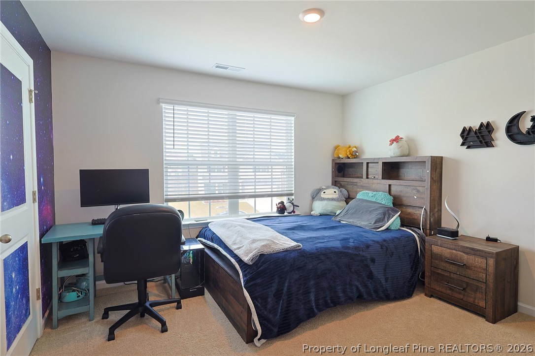 2129 Clydesmill Road Fayetteville, NC 28314 - Photo 29 of 36 a bedroom with a bed and a chair