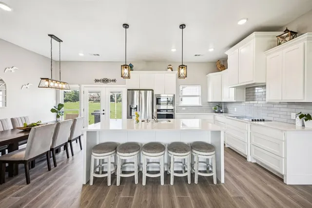 a large kitchen with a table and chairs