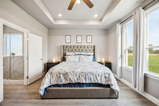 a bedroom with a large bed and a chandelier