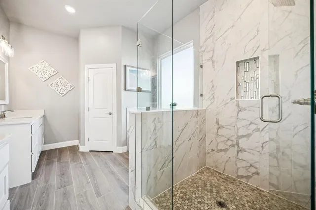 a bathroom with a tub a sink and a window