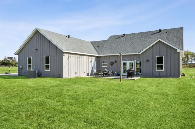 a front view of house with yard and outdoor seating