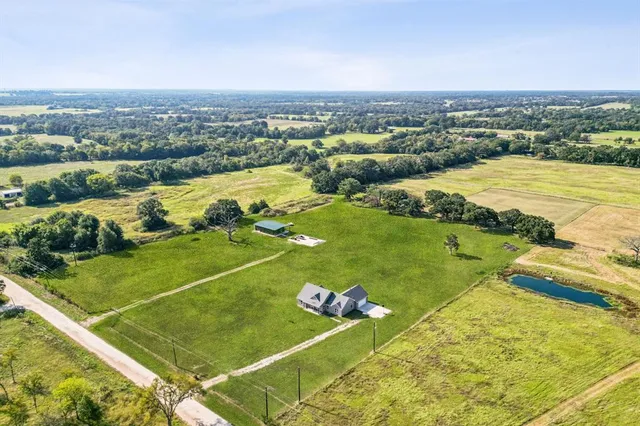 a view of a house with a yard and a garage
